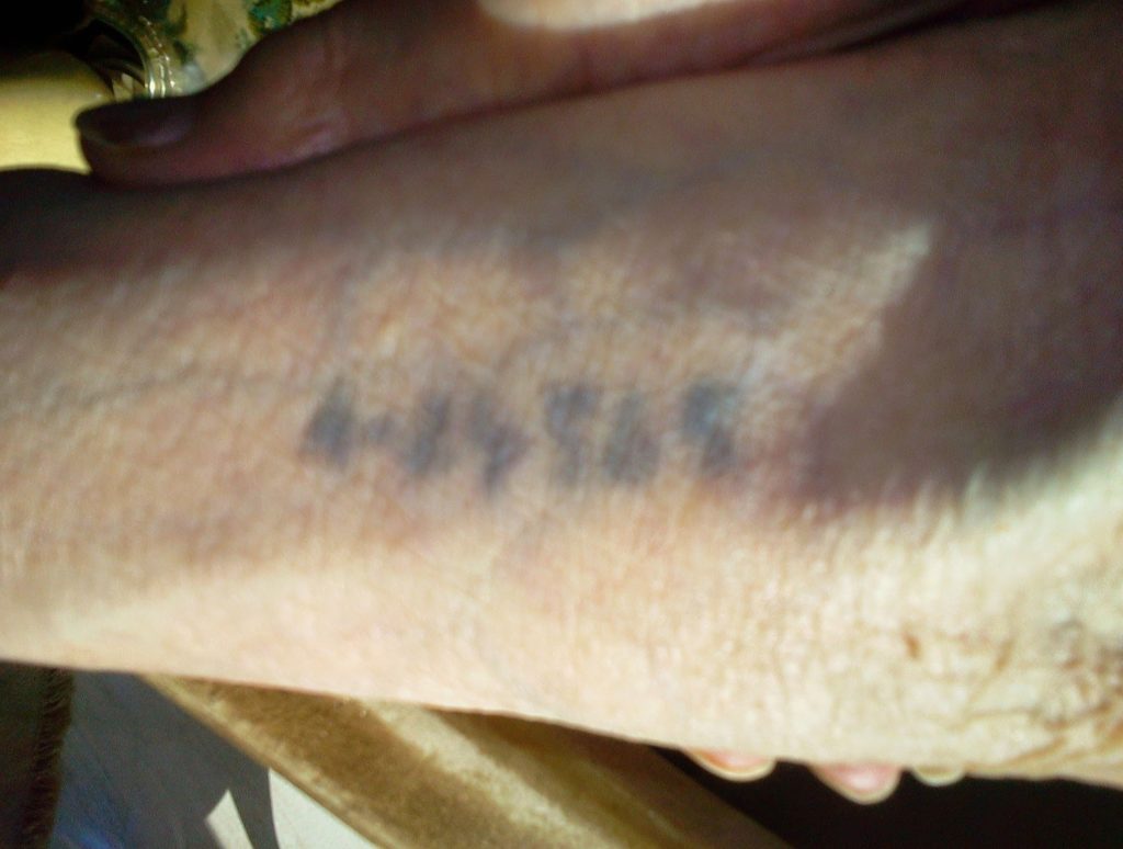 Image of The tattooed forearm of Malka Freidenreich Kempner.